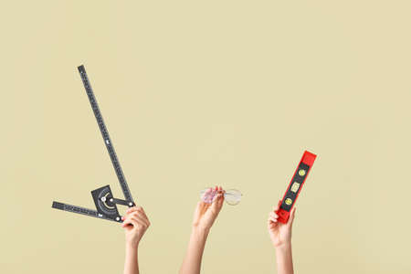 Hands with architect's supplies on color backgroundの写真素材