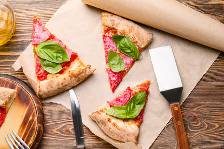 Slices of tasty pizza on wooden tableの写真素材
