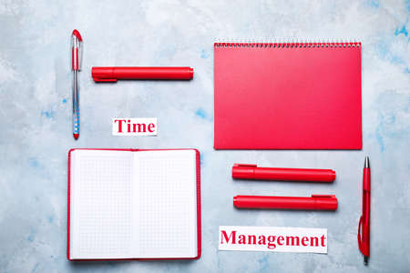 Stationery and text TIME MANAGEMENT on color backgroundの写真素材
