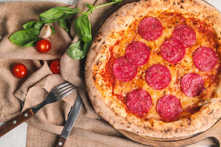 Board with tasty pizza on tableの写真素材