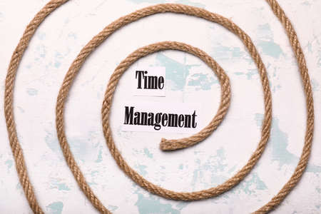 Rope and text TIME MANAGEMENT on color backgroundの写真素材