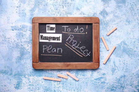 Chalkboard with text on color background. Time management conceptの写真素材