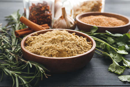 Plate with spices on dark wooden backgroundの写真素材