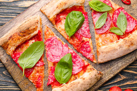 Slices of tasty pizza on wooden boardの写真素材