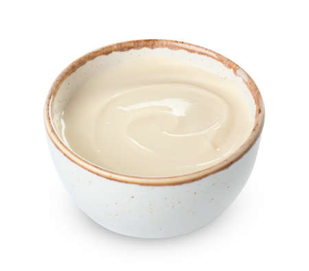 Bowl with tasty cream cheese on white backgroundの写真素材