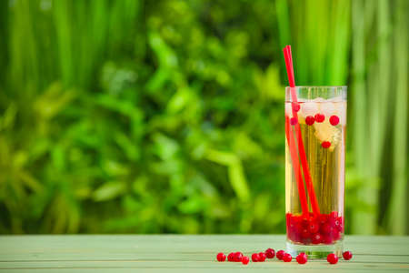 Glass with cold tea on table outdoorsの写真素材