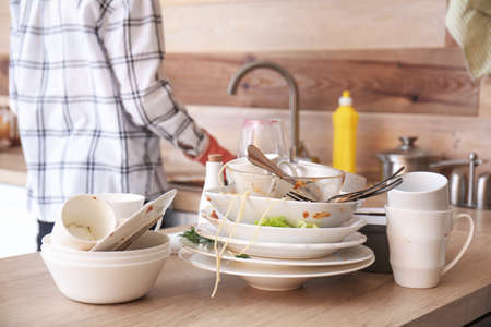 Many dirty dishes on kitchen tableの写真素材