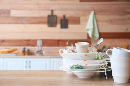 Many dirty dishes on kitchen tableの写真素材