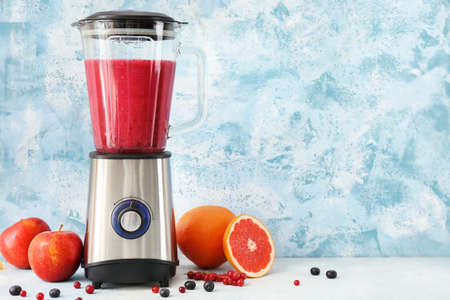 Blender with ingredients for healthy smoothie on tableの写真素材