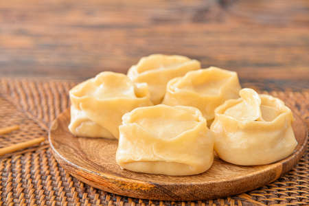Plate with oriental dumplings on tableの写真素材