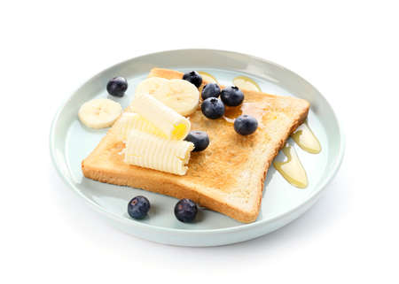 Tasty toasted bread with honey, butter and fruits on white backgroundの写真素材