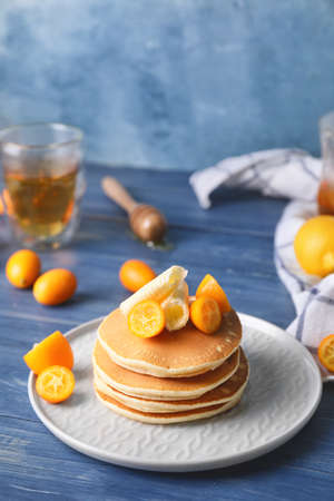 Tasty pancakes with butter and citrus fruit on plateの写真素材