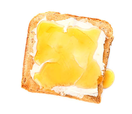 Tasty toasted bread with honey and butter on white backgroundの写真素材