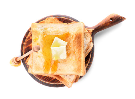 Tasty toasted bread with honey and butter on white backgroundの写真素材