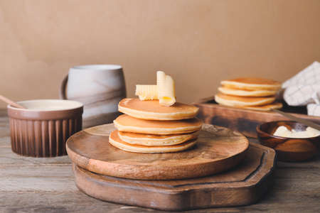 Tasty pancakes with butter on tableの写真素材
