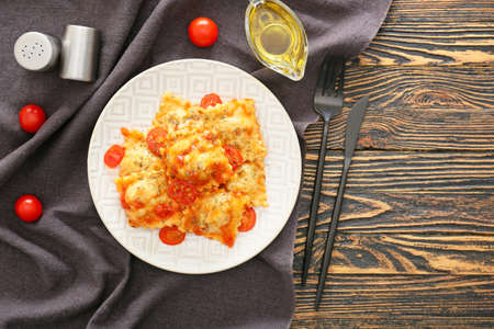 Plate with tasty ravioli on tableの写真素材