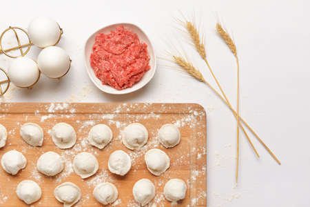 Preparing of tasty dumplings on white backgroundの写真素材