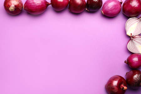 Fresh raw onion on color backgroundの写真素材