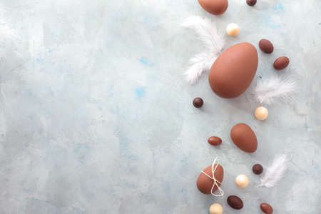 Tasty chocolate Easter eggs on light background