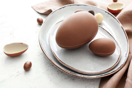 Tasty chocolate Easter eggs on light backgroundの写真素材