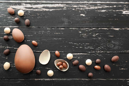 Tasty chocolate Easter eggs on wooden backgroundの写真素材