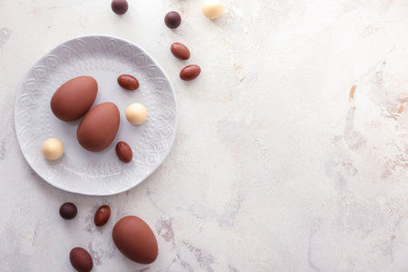 Tasty chocolate Easter eggs on light backgroundの写真素材