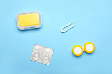 Containers for contact lenses and tweezers on color backgroundの写真素材