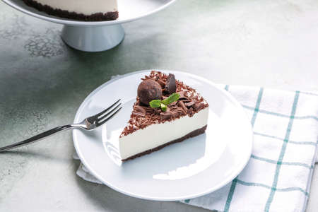 Plate with piece of chocolate cheesecake on tableの写真素材