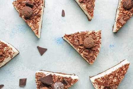 Pieces of tasty chocolate cheesecake on color backgroundの写真素材