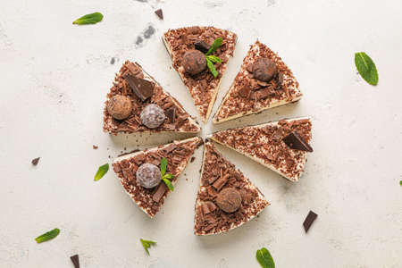 Pieces of tasty chocolate cheesecake on white backgroundの写真素材