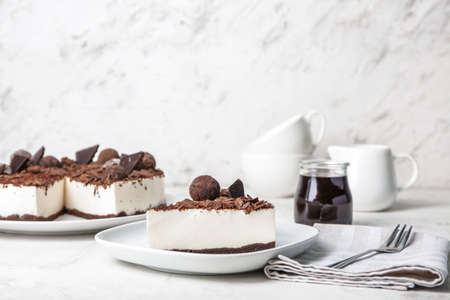 Plate with piece of chocolate cheesecake on tableの写真素材