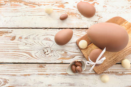 Tasty chocolate Easter eggs on wooden background