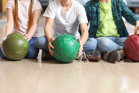 Little children playing bowling in clubの写真素材