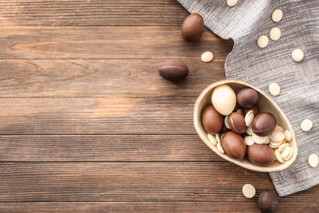 Sweet chocolate Easter eggs on wooden backgroundの写真素材
