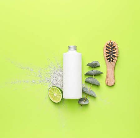 Shampoo with natural extract and brush on color backgroundの写真素材