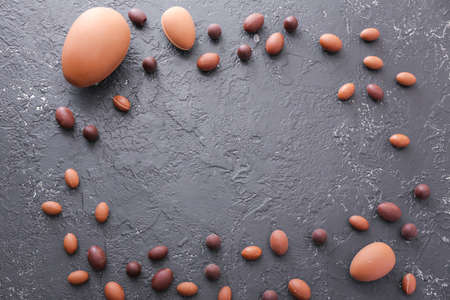 Frame made of chocolate Easter eggs on gray backgroundの写真素材