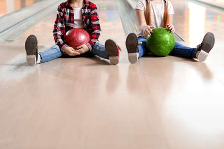 Little girls playing bowling in clubの写真素材