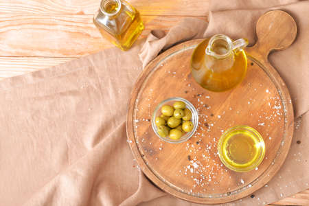 Tasty olive oil on wooden tableの写真素材