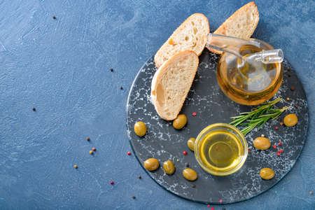 Tasty olive oil with bread on dark backgroundの写真素材