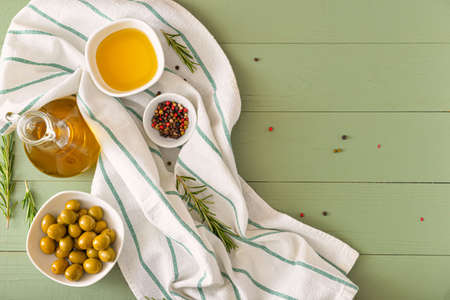 Tasty olive oil with spices on wooden tableの写真素材