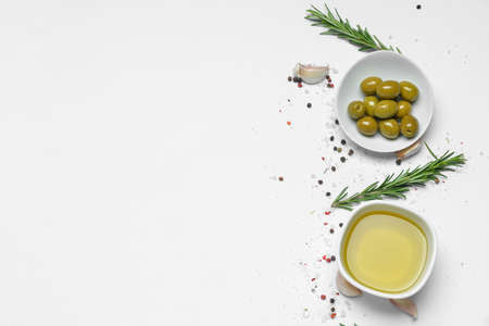 Bowl of tasty olive oil and spices on white backgroundの写真素材