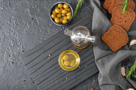 Tasty olive oil with bread on dark backgroundの写真素材
