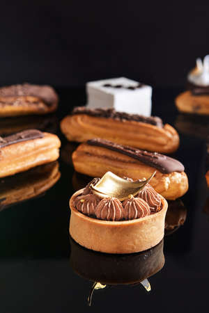 Tasty cakes on dark background