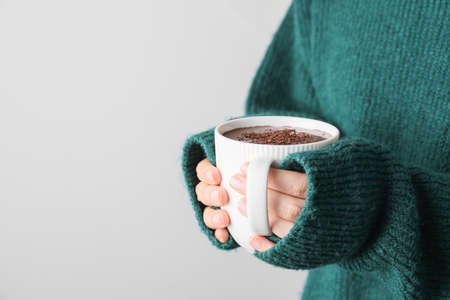 Woman with cup of hot chocolate, closeup