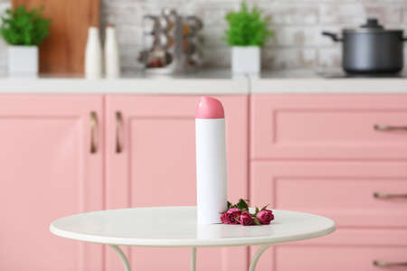 Bottle of air freshener on table in kitchenの写真素材