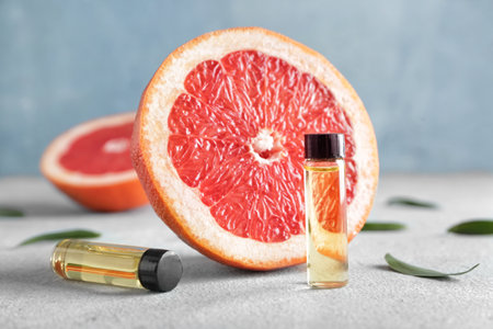 Bottles of grapefruit essential oil on tableの写真素材