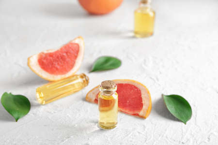 Bottles of grapefruit essential oil on tableの写真素材
