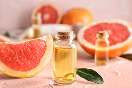 Bottles of grapefruit essential oil on tableの写真素材