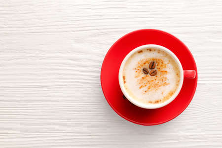 Cup of tasty cappuccino on white wooden backgroundの写真素材