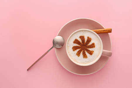Cup of tasty cappuccino on color backgroundの写真素材
